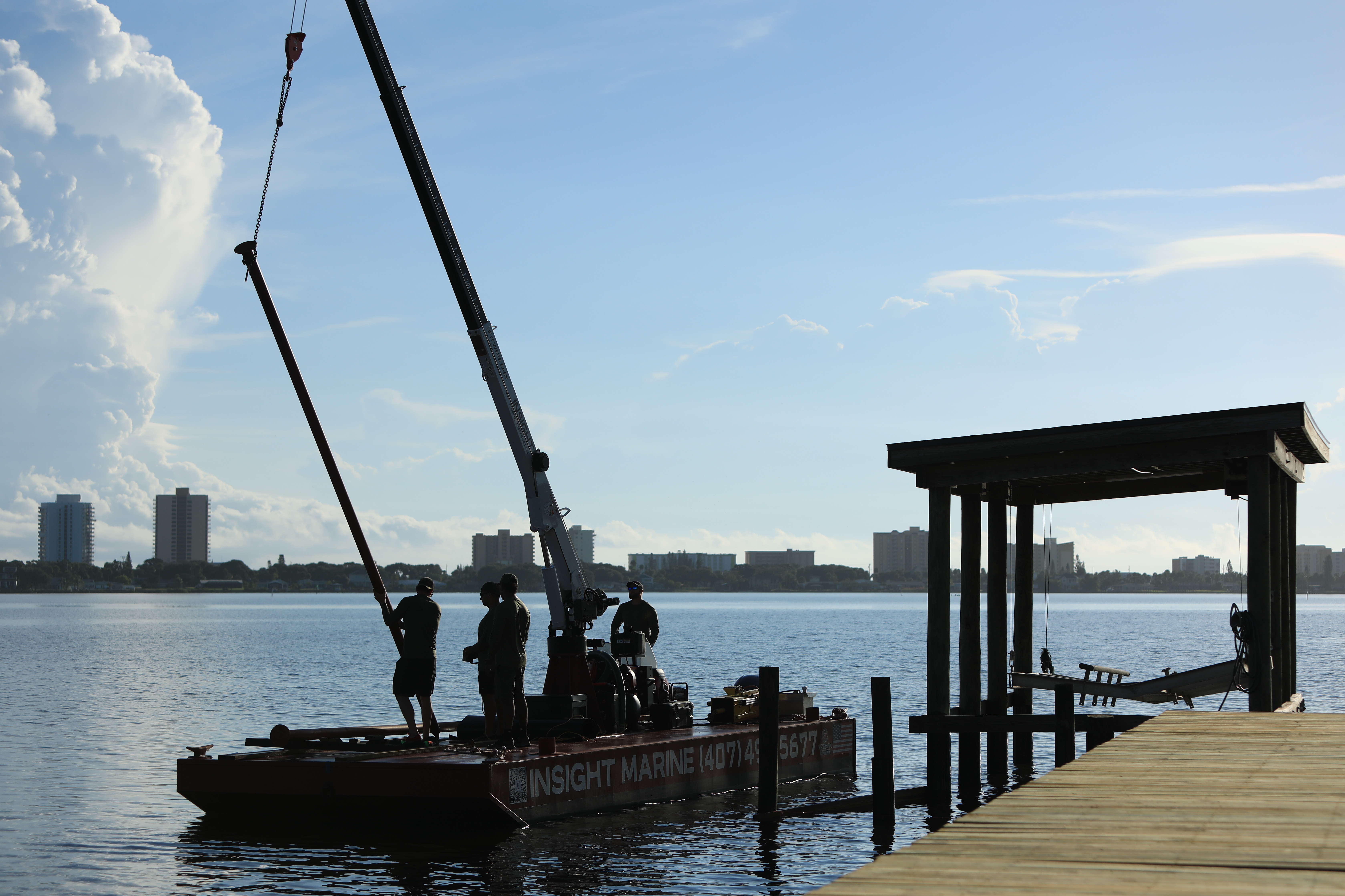 Insight Marine work barge and crane tied to a dock on the Halifax River