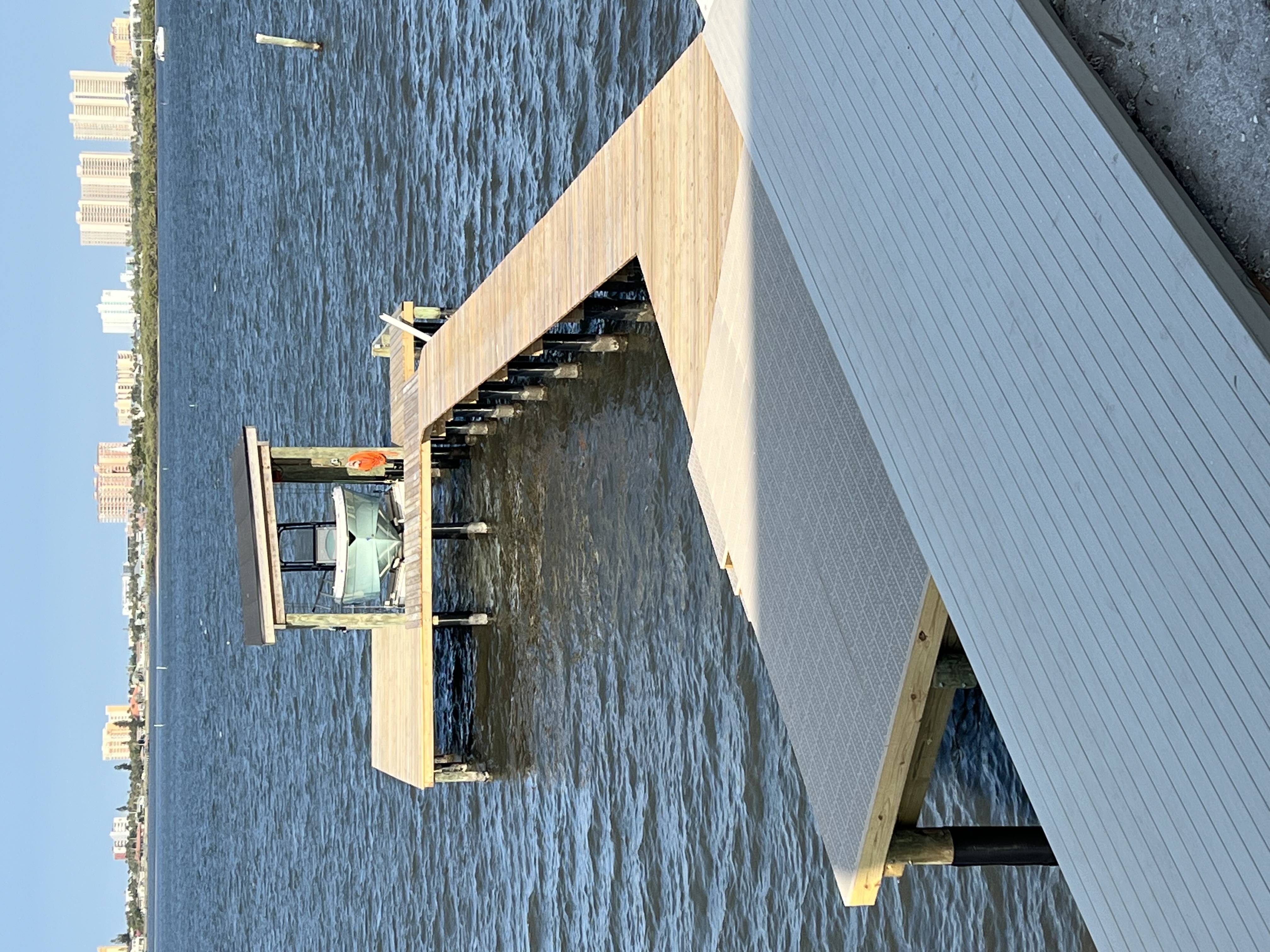 Covered boat lift with a center console boat raised out of the water
