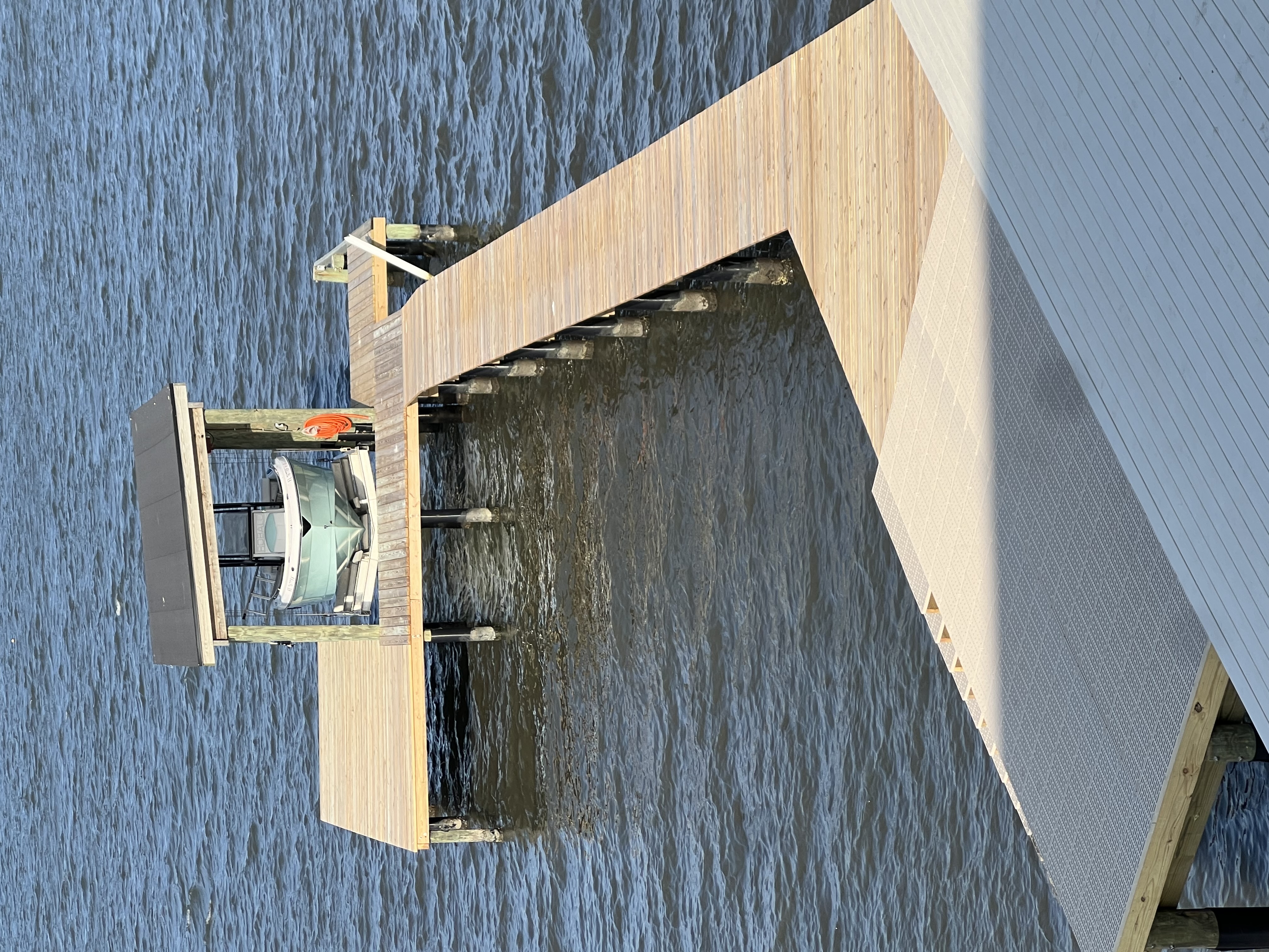 Composite sundeck and timber walkway with a covered lift beyond