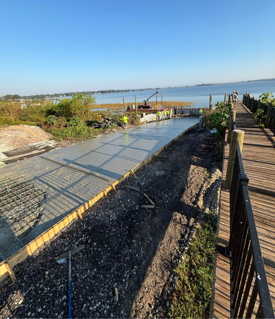 Finished concrete community boat ramp running down to a lake