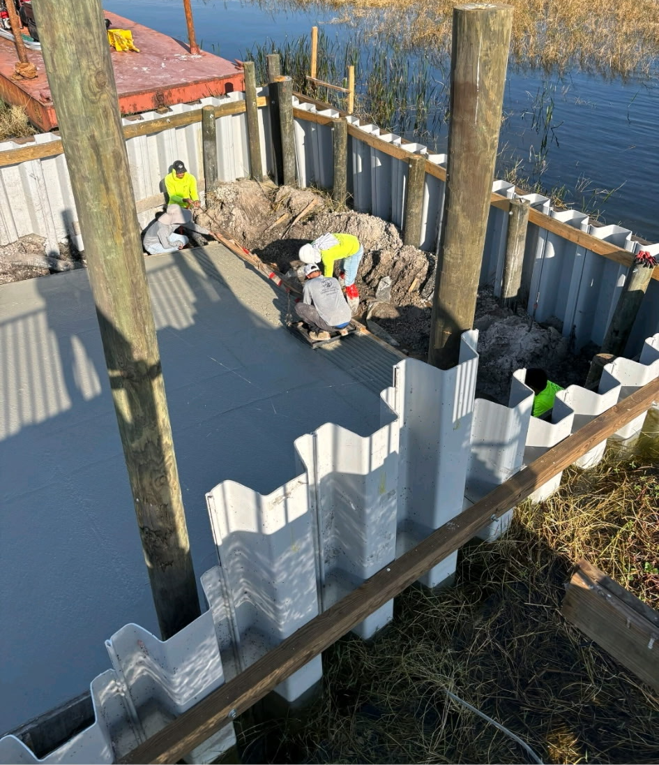 Vinyl sheet pile seawall installed with timber piles and a poured cap