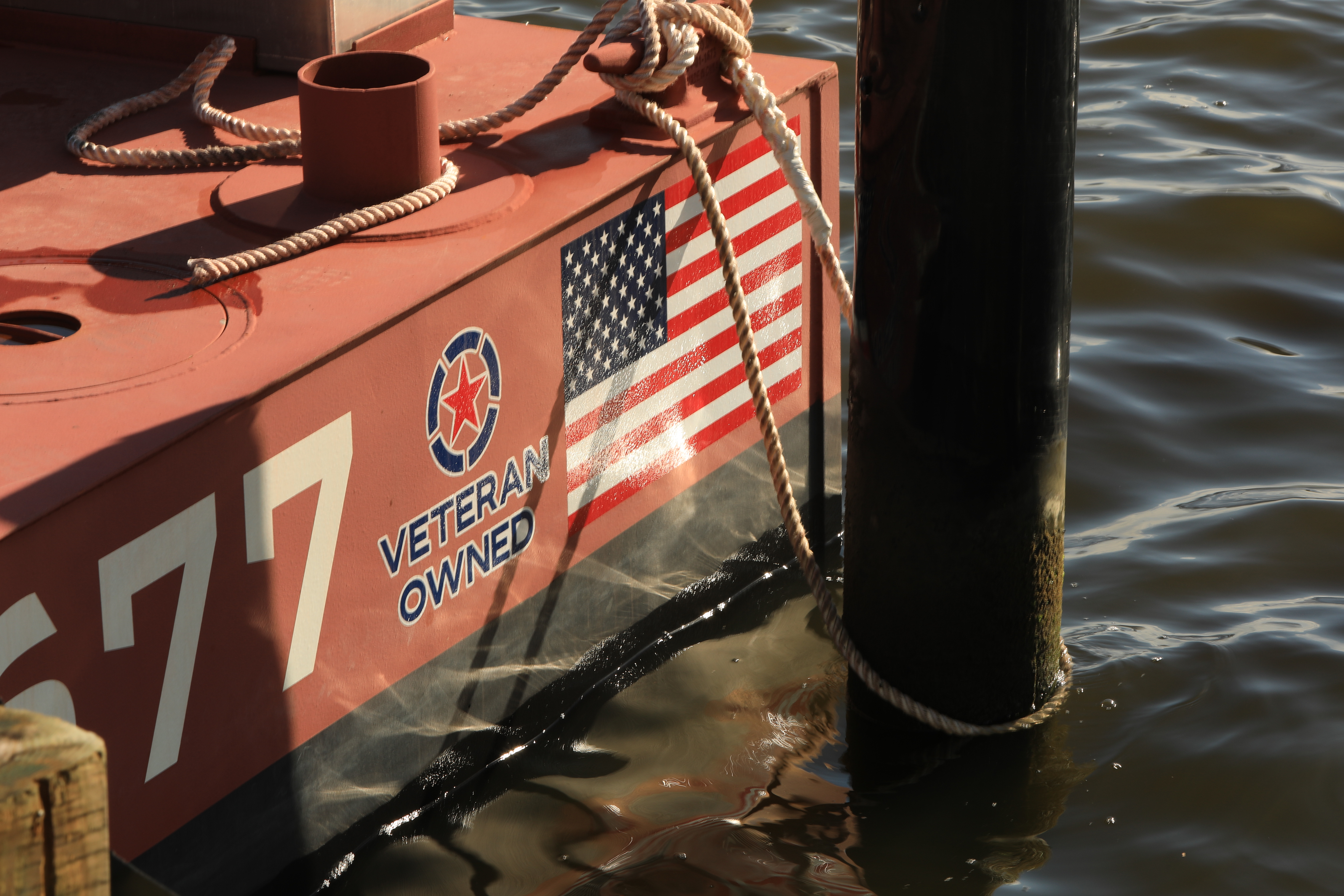 Veteran Owned decal and American flag painted on the barge hull